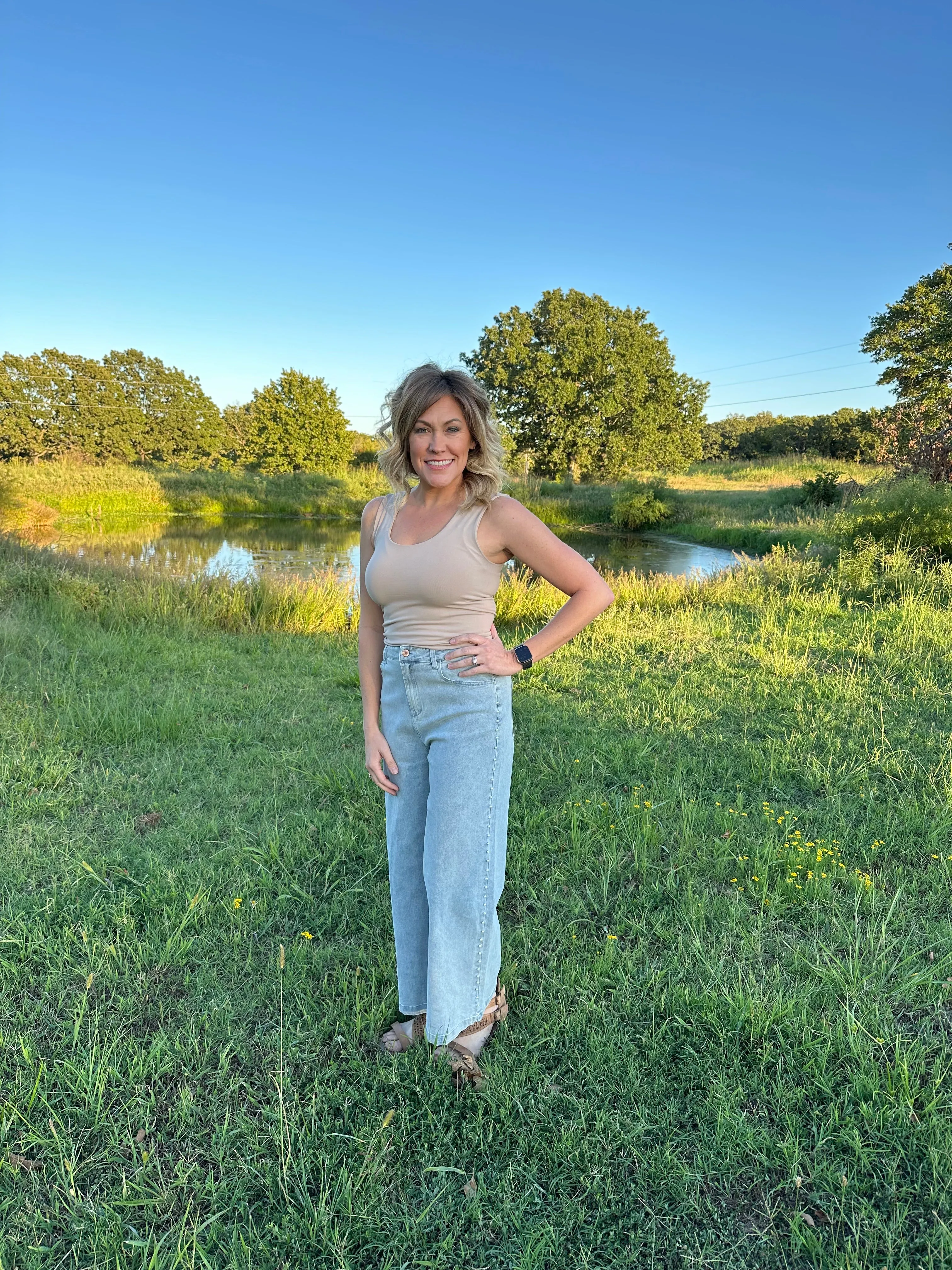 High waisted denim wide leg pants w/ pearl details @ side. Pockets @ front & back. Zipper.